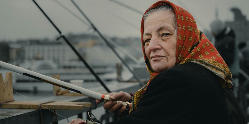 woman fishing on bridge during daytime