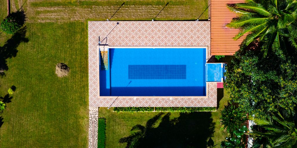 an aerial view of a house with a swimming pool